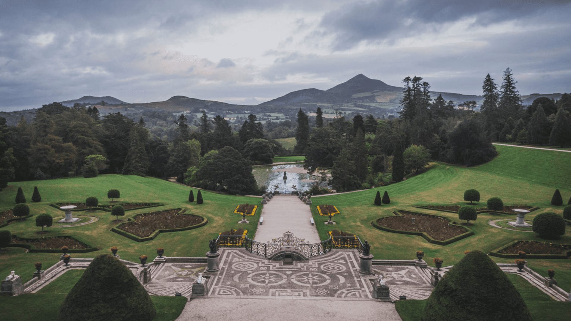Wide aerial view of the Powerscourt House and Gardens,with Sugar Loaf Mountain in the background, Ireland.