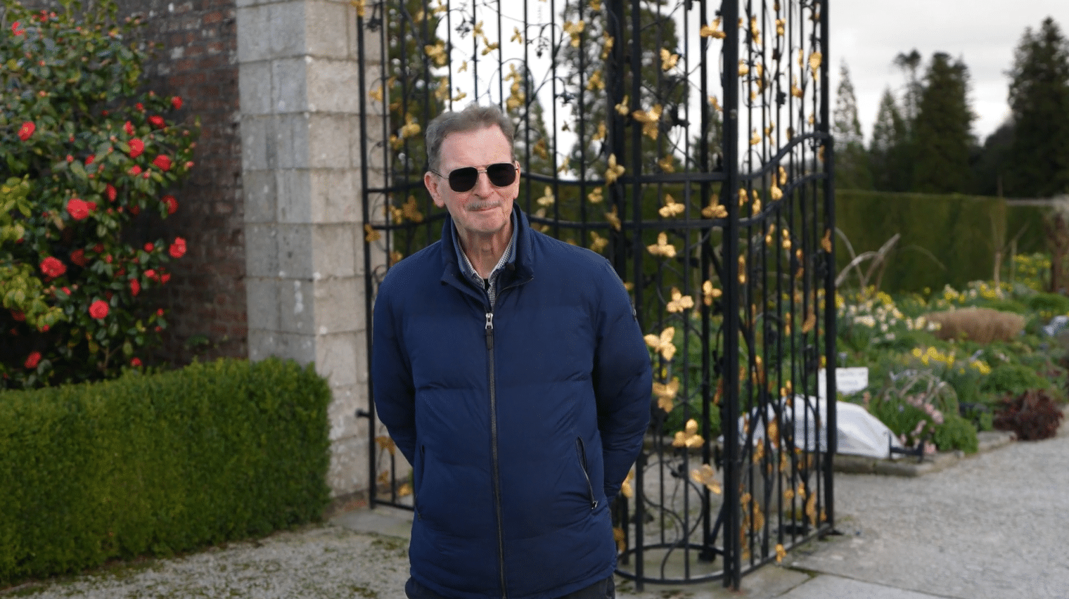 Licensed private tour guide John Ducie standing at the ornamental Vine Leaf Gates at Powerscourt Gardens, County Wicklow, Ireland