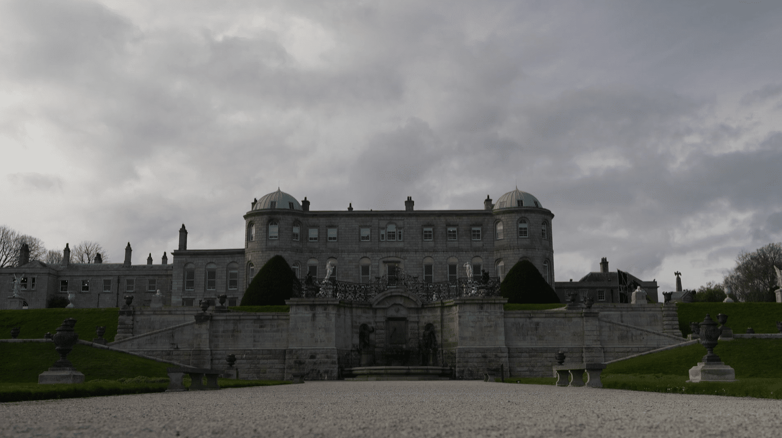 Front facade of Powerscourt House, one of Ireland's finest Palladian mansions, with its twin copper domes and ornamental ironwork gates, Enniskerry, County Wicklow